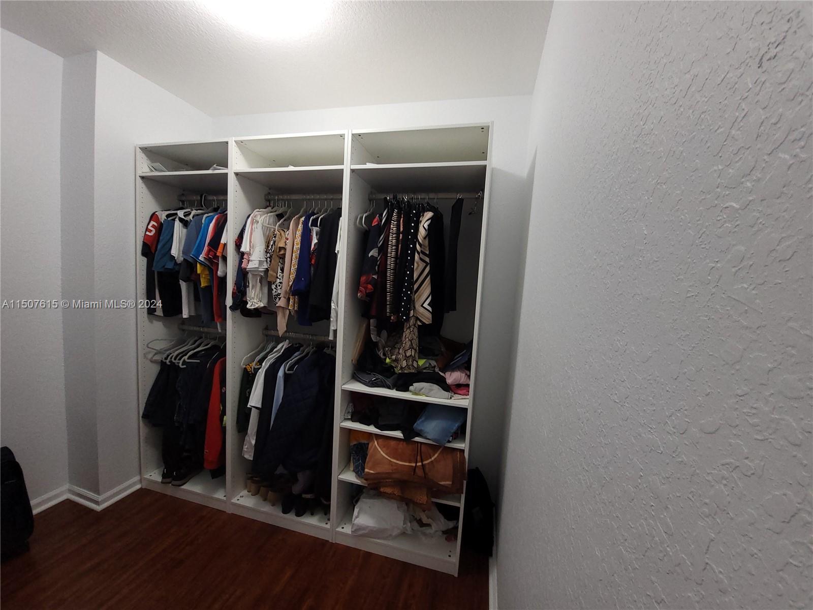 293 Las Brisas Circle Sunrise, FL 33326 - Photo 30 of 69 a view of walk in closet with clothes and shoes
