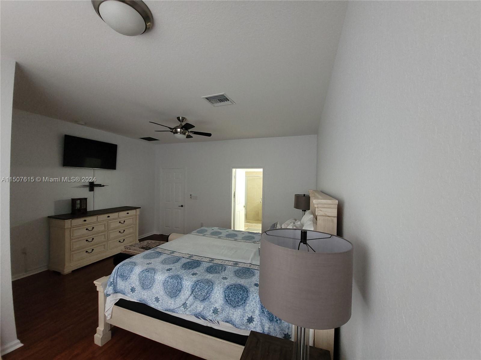 293 Las Brisas Circle Sunrise, FL 33326 - Photo 33 of 69 a bedroom with a bed and a flat screen tv