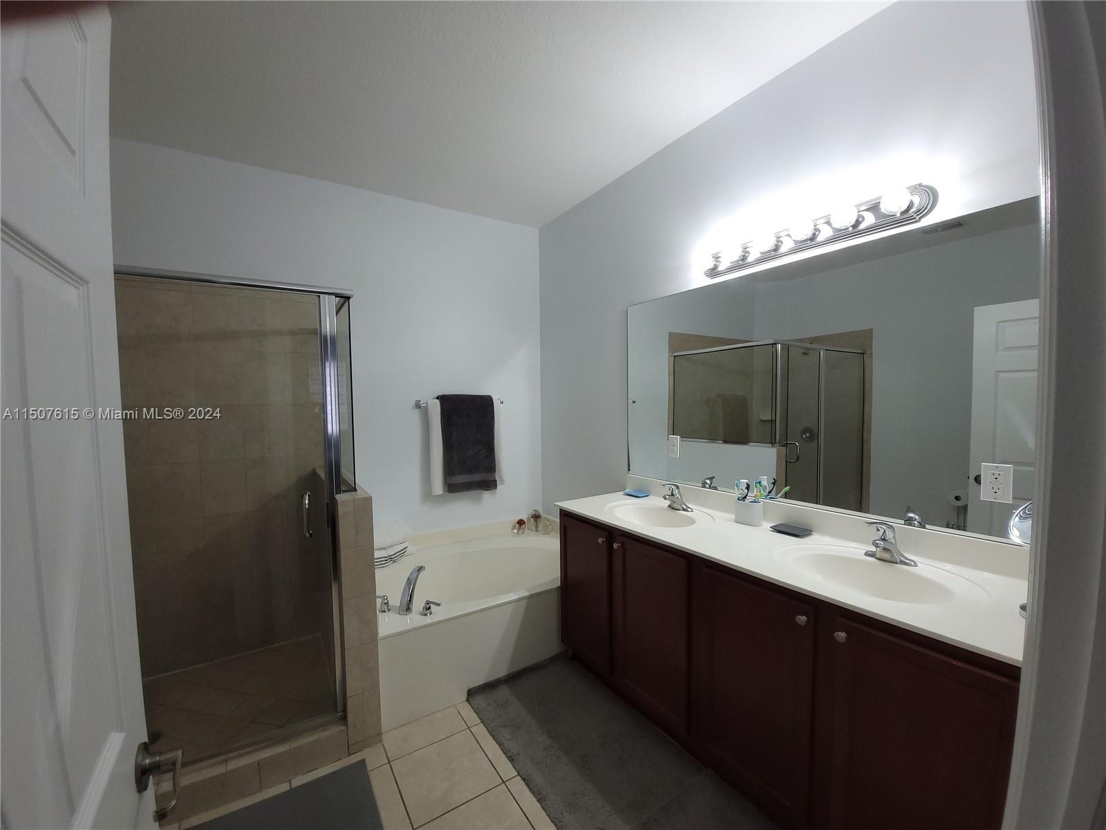 293 Las Brisas Circle Sunrise, FL 33326 - Photo 34 of 69 a bathroom with a double vanity sink a mirror and shower