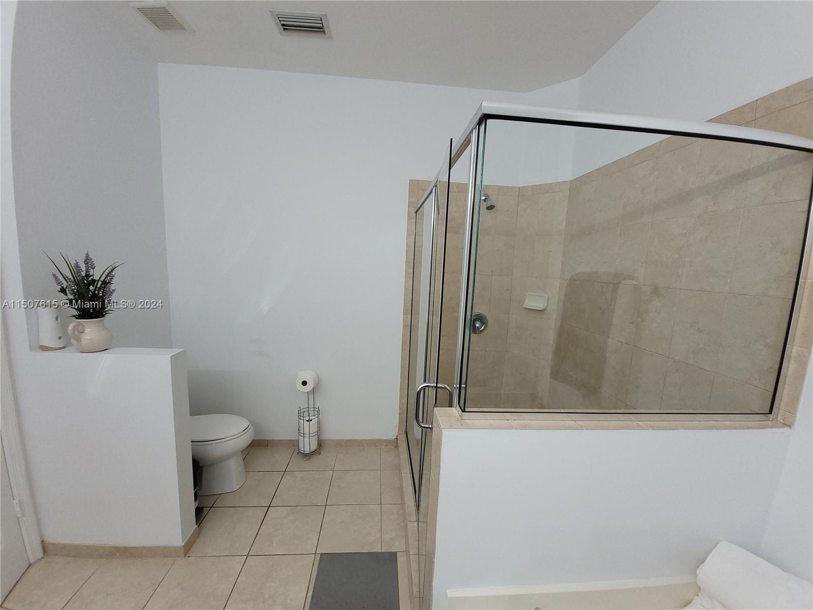 293 Las Brisas Circle Sunrise, FL 33326 - Photo 35 of 69 a bathroom with a shower and a toilet