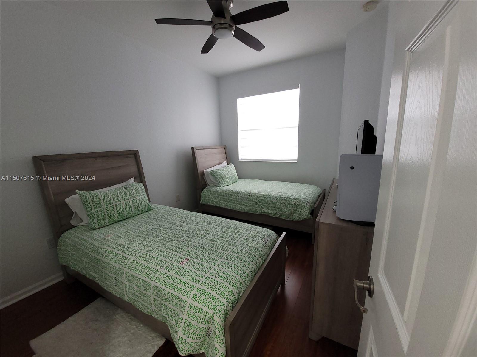 293 Las Brisas Circle Sunrise, FL 33326 - Photo 37 of 69 a bedroom with two beds and a window