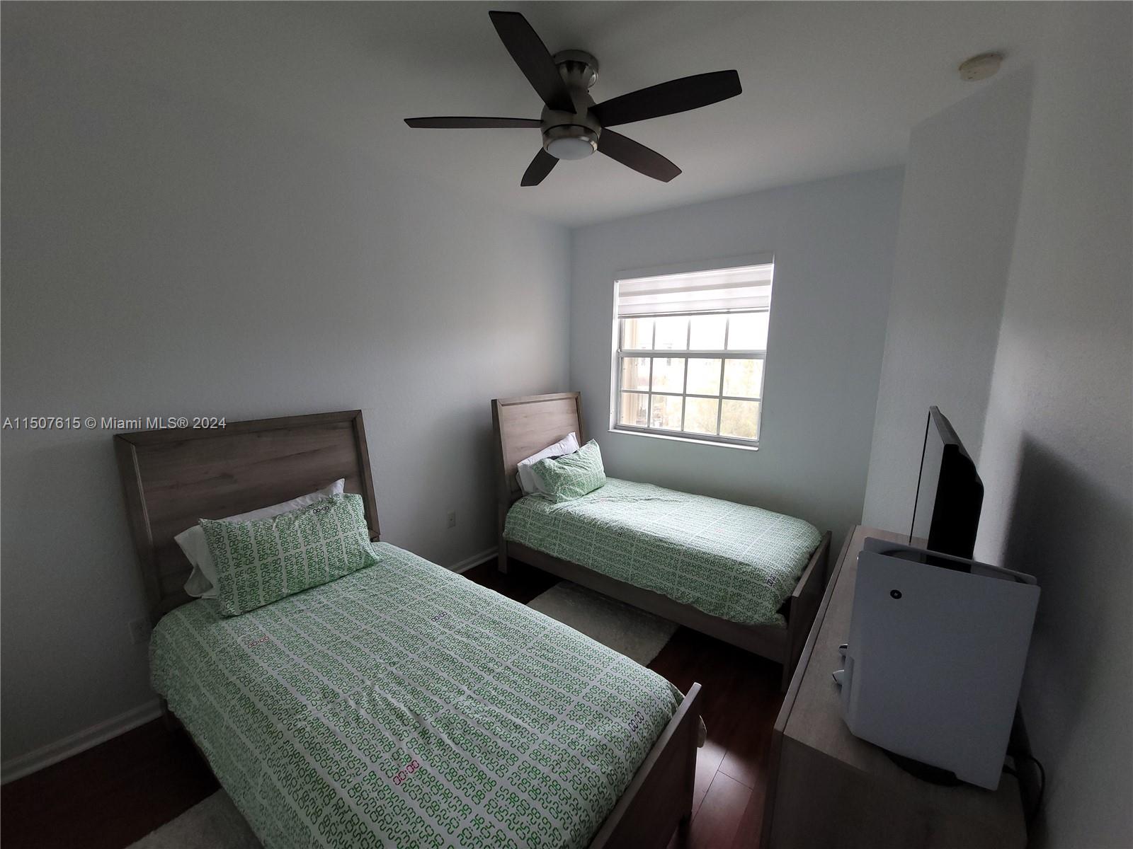 293 Las Brisas Circle Sunrise, FL 33326 - Photo 39 of 69 a bedroom with a bed a couch and a window