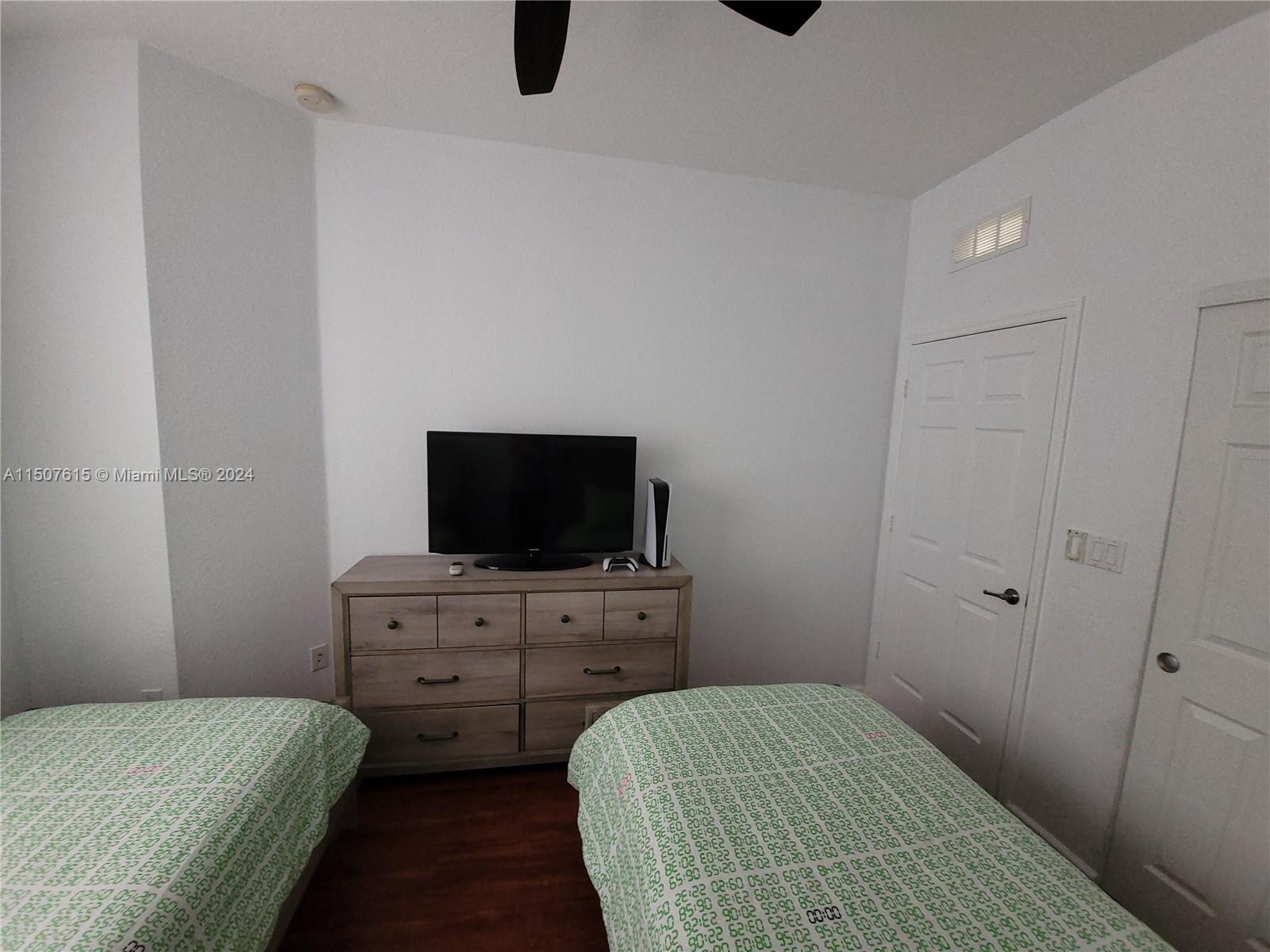 293 Las Brisas Circle Sunrise, FL 33326 - Photo 41 of 69 a bedroom with a bed and a flat screen tv