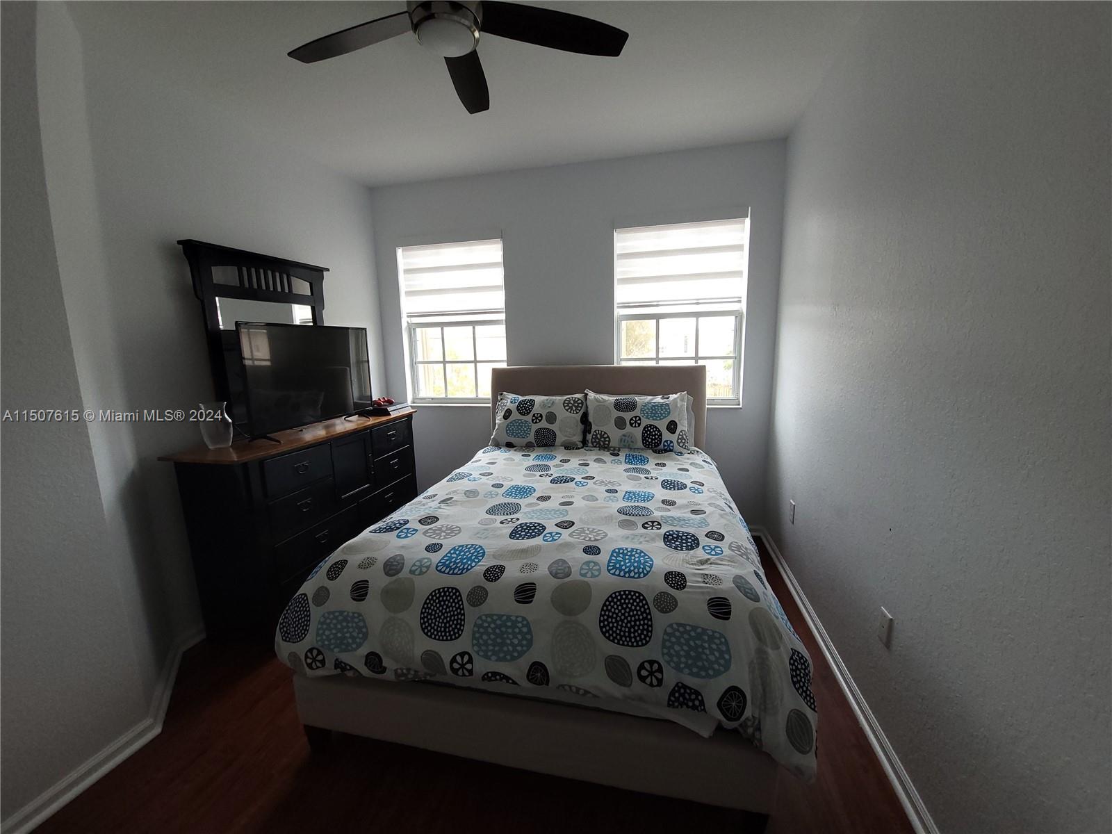 293 Las Brisas Circle Sunrise, FL 33326 - Photo 48 of 69 a bedroom with a bed and a flat tv screen on the dresser