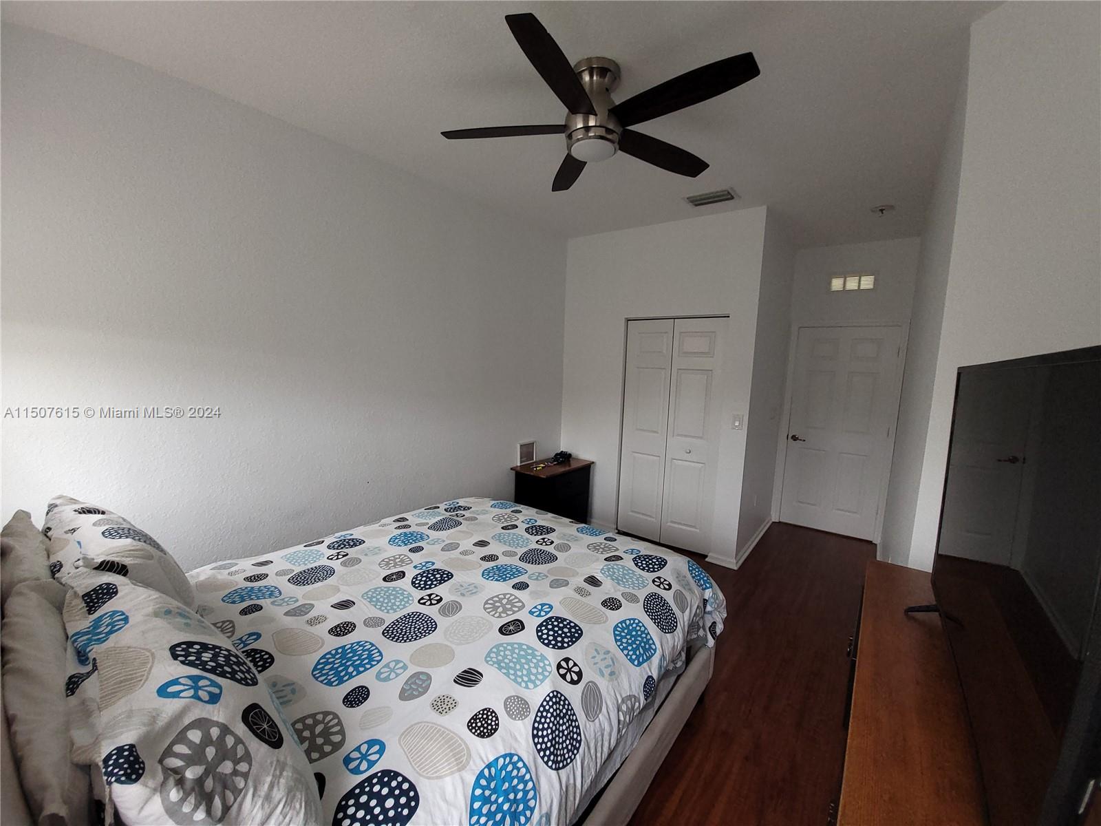 293 Las Brisas Circle Sunrise, FL 33326 - Photo 49 of 69 a bedroom with a bed and a flat tv screen on the dresser