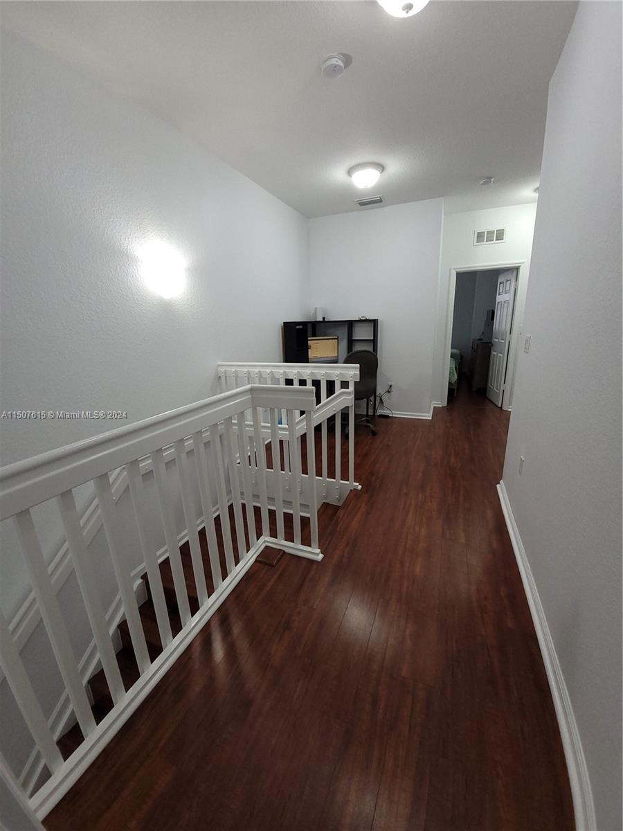 293 Las Brisas Circle Sunrise, FL 33326 - Photo 50 of 69 a view of an empty room with wooden floor