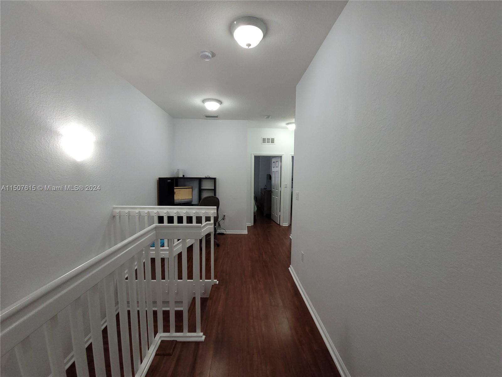 293 Las Brisas Circle Sunrise, FL 33326 - Photo 51 of 69 a view of a hallway with wooden floor
