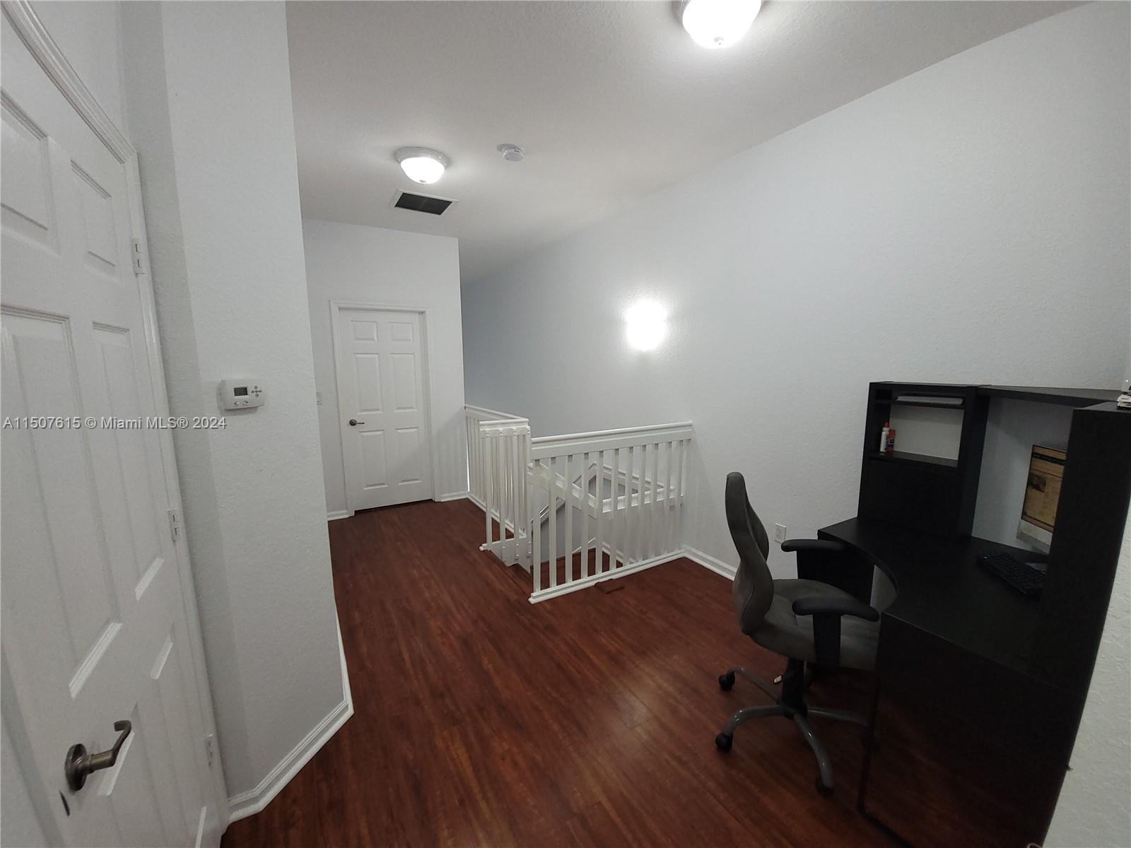 293 Las Brisas Circle Sunrise, FL 33326 - Photo 52 of 69 a view of a workspace with furniture and wooden floor