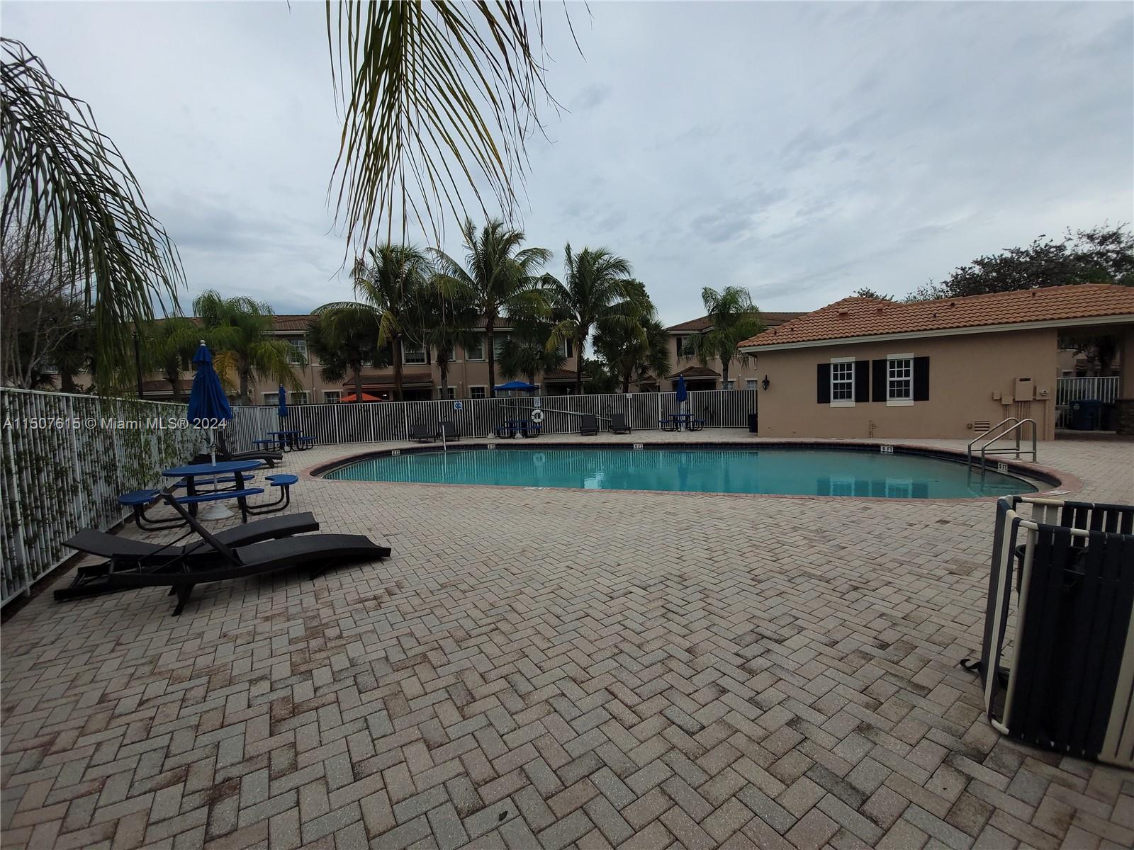 293 Las Brisas Circle Sunrise, FL 33326 - Photo 67 of 69 a front view of a house with garden and trees