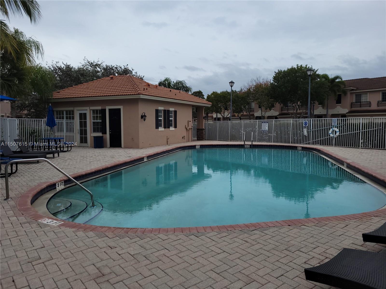 293 Las Brisas Circle Sunrise, FL 33326 - Photo 68 of 69 a view of a house with pool fire pit and a yard
