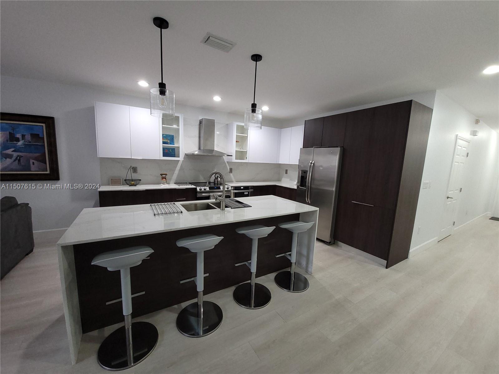 293 Las Brisas Circle Sunrise, FL 33326 - Photo 7 of 69 a kitchen with stainless steel appliances granite countertop a sink a stove a refrigerator and island