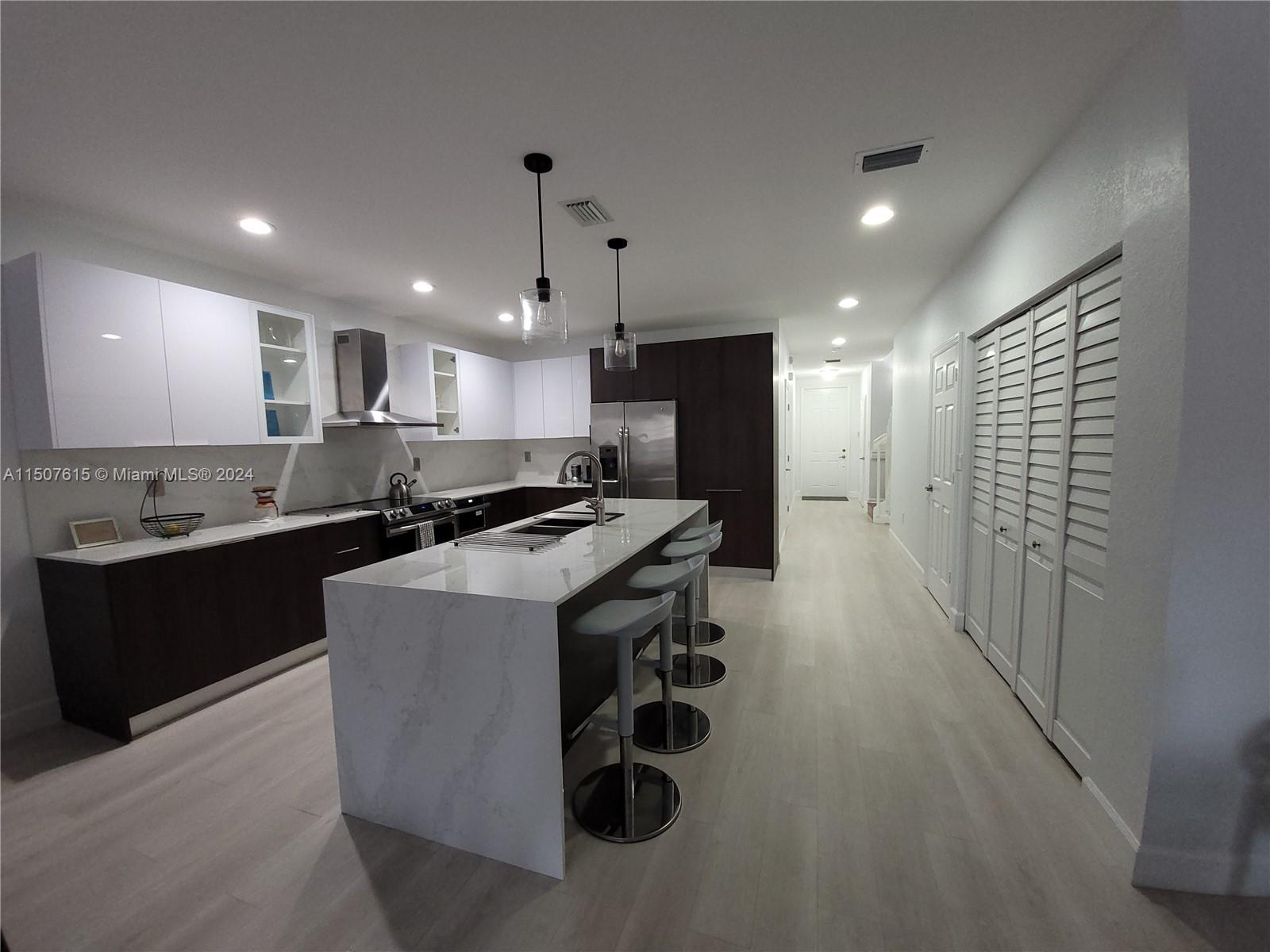 293 Las Brisas Circle Sunrise, FL 33326 - Photo 8 of 69 a kitchen with stainless steel appliances granite countertop a sink a stove a refrigerator and a oven