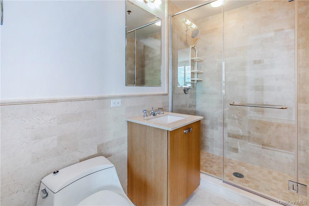 1 Renaissance Square, Unit 11G White Plains, NY 10601 - Photo 12 of 23 a bathroom with a sink a toilet and shower