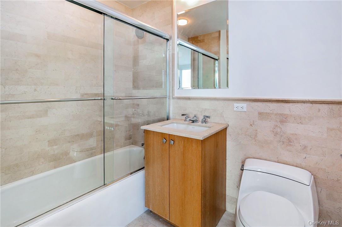 1 Renaissance Square, Unit 11G White Plains, NY 10601 - Photo 13 of 23 a bathroom with a granite countertop sink toilet and shower
