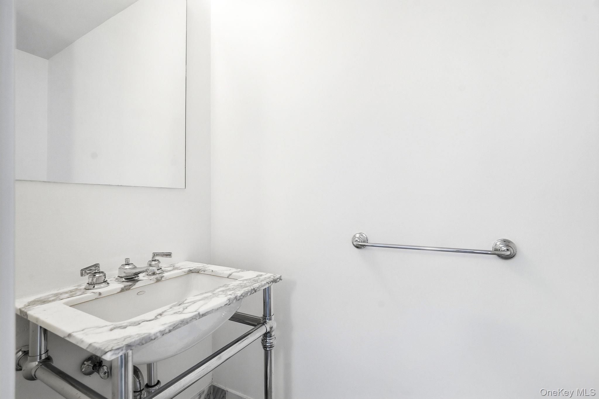 1 Renaissance Square, Unit 11G White Plains, NY 10601 - Photo 13 of 28 a bathroom with a sink and vanity