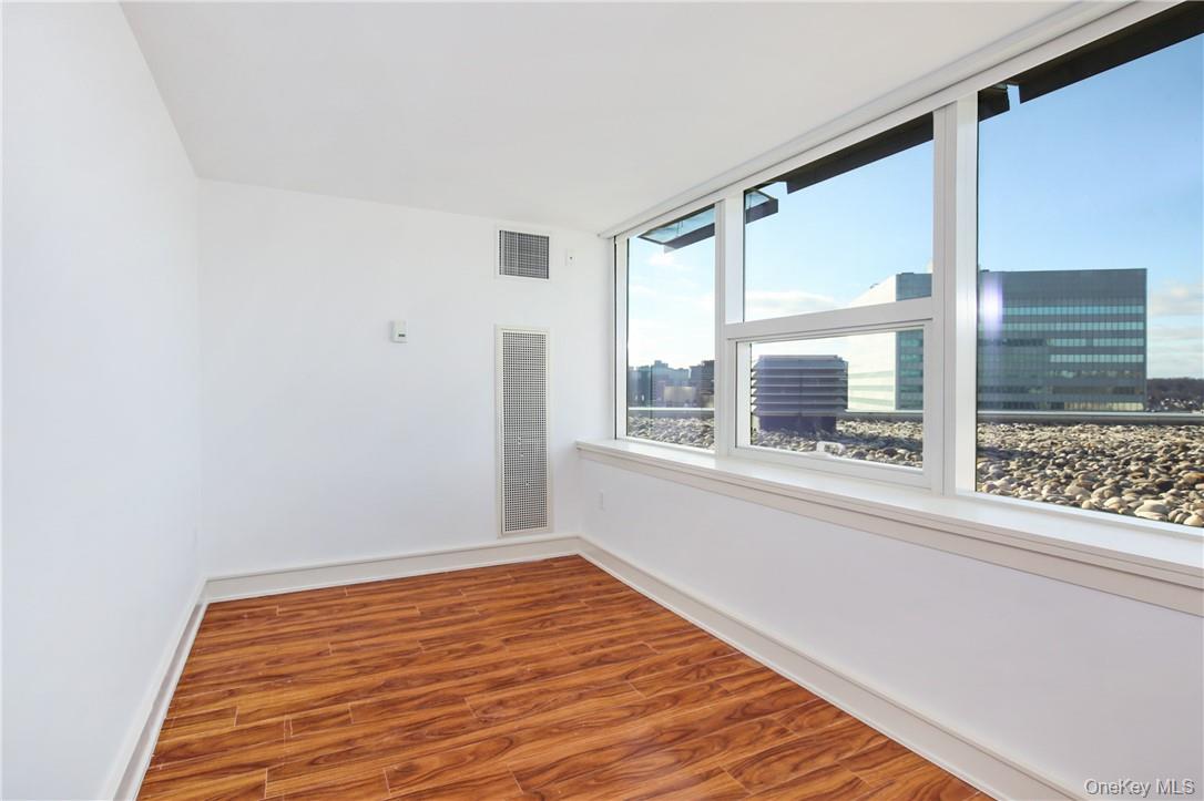 1 Renaissance Square, Unit 11G White Plains, NY 10601 - Photo 17 of 23 a view of a room with wooden floor and a window