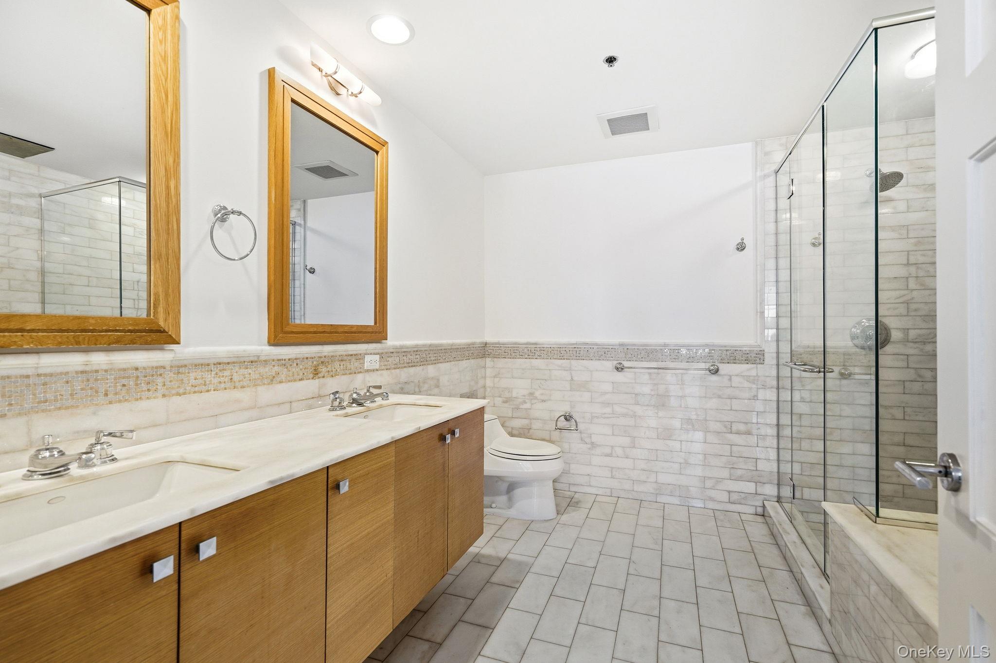 1 Renaissance Square, Unit 11G White Plains, NY 10601 - Photo 19 of 28 a bathroom with a sink a toilet and shower