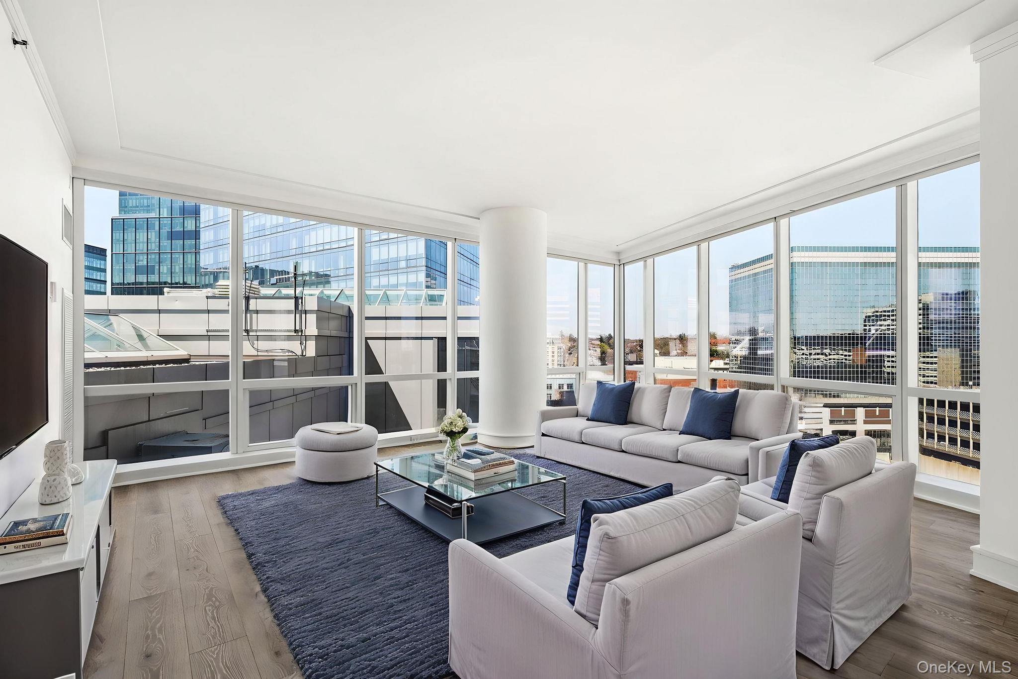 1 Renaissance Square, Unit 11G White Plains, NY 10601 - Photo 2 of 28 a living room with furniture and a floor to ceiling window