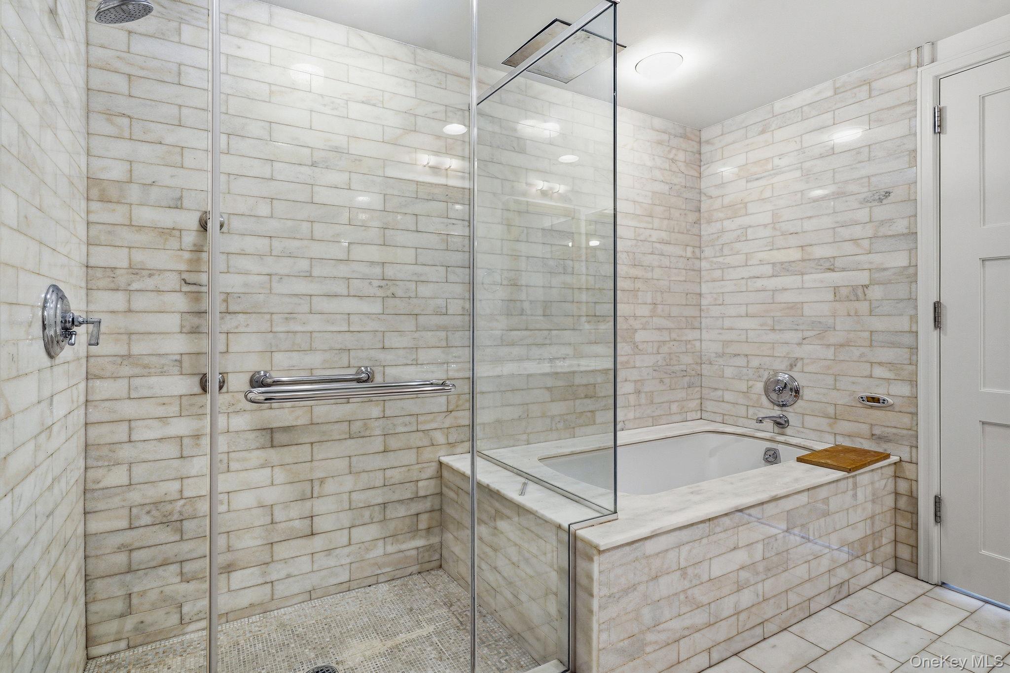 1 Renaissance Square, Unit 11G White Plains, NY 10601 - Photo 21 of 28 a bathroom with a bathtub and shower