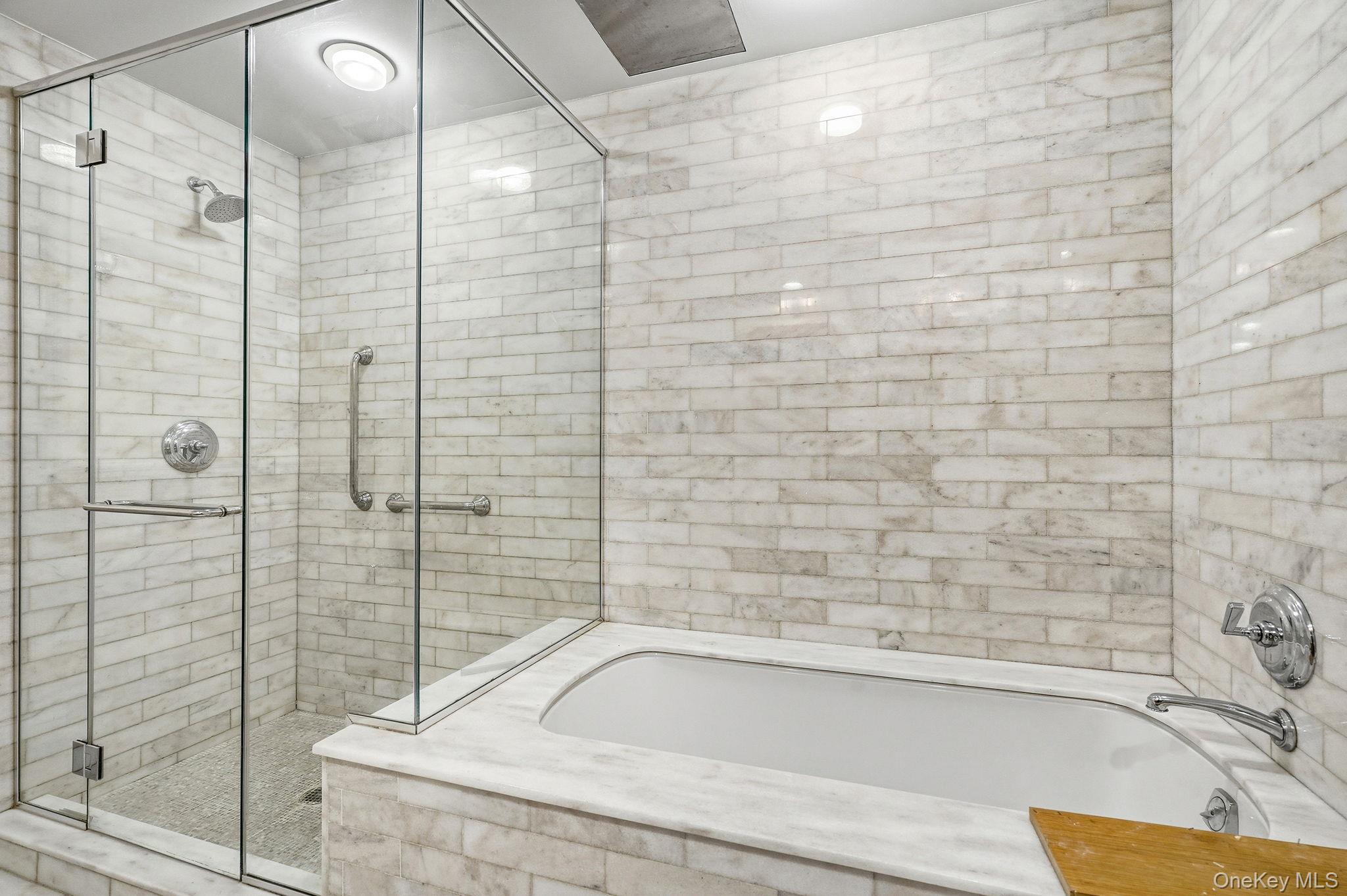 1 Renaissance Square, Unit 11G White Plains, NY 10601 - Photo 22 of 28 a bathroom with a bathtub and shower