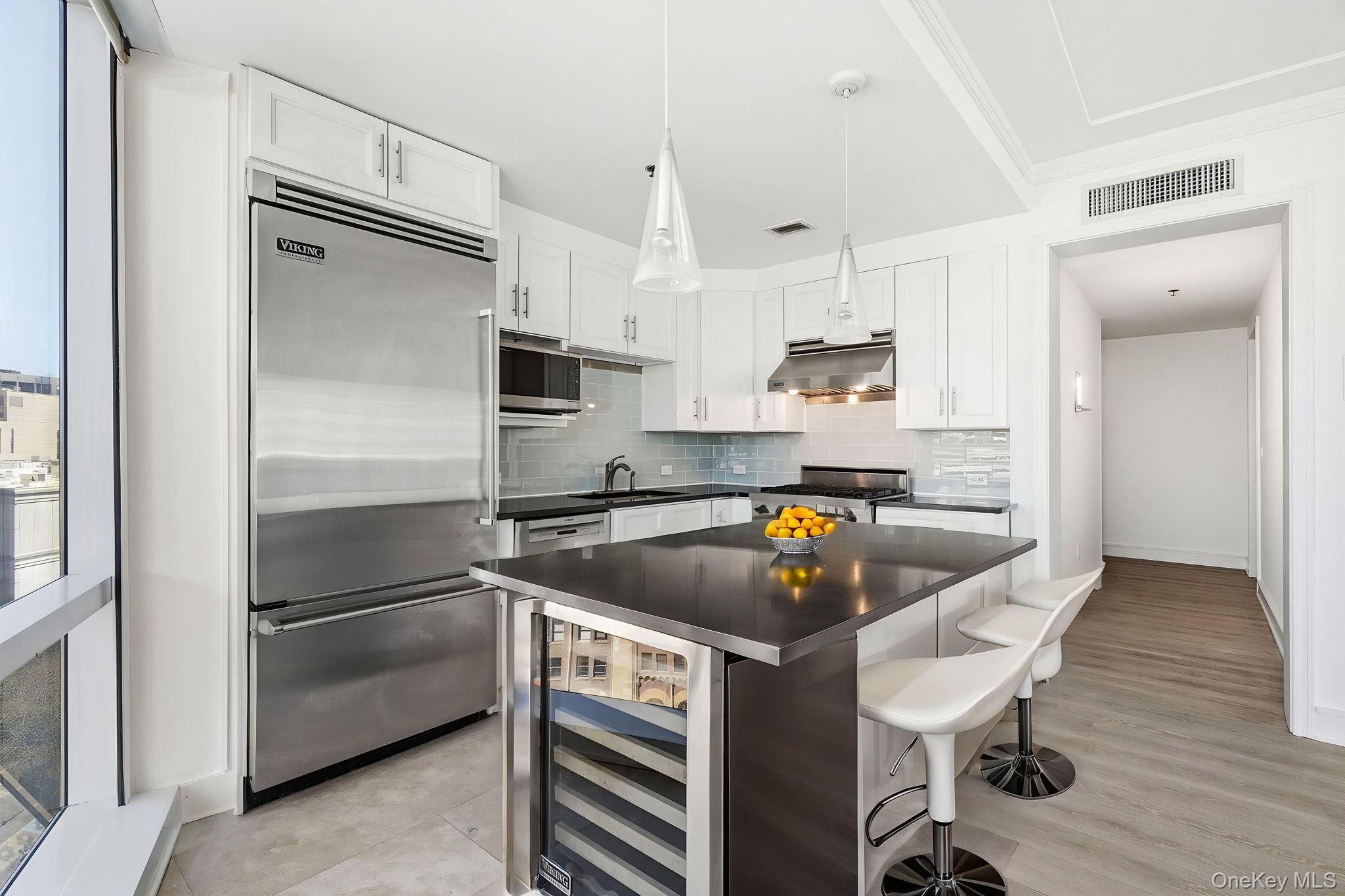 1 Renaissance Square, Unit 11G White Plains, NY 10601 - Photo 3 of 28 a kitchen with a refrigerator a sink and cabinets
