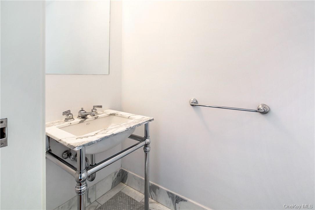 1 Renaissance Square, Unit 11G White Plains, NY 10601 - Photo 7 of 23 a bathroom with a sink and a mirror