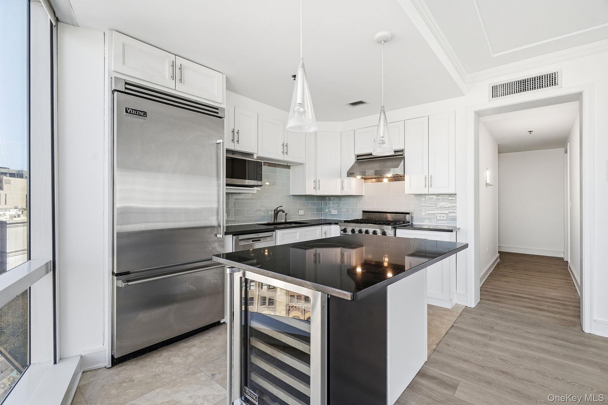 1 Renaissance Square, Unit 11G White Plains, NY 10601 - Photo 7 of 28 a kitchen with kitchen island a sink stove and refrigerator