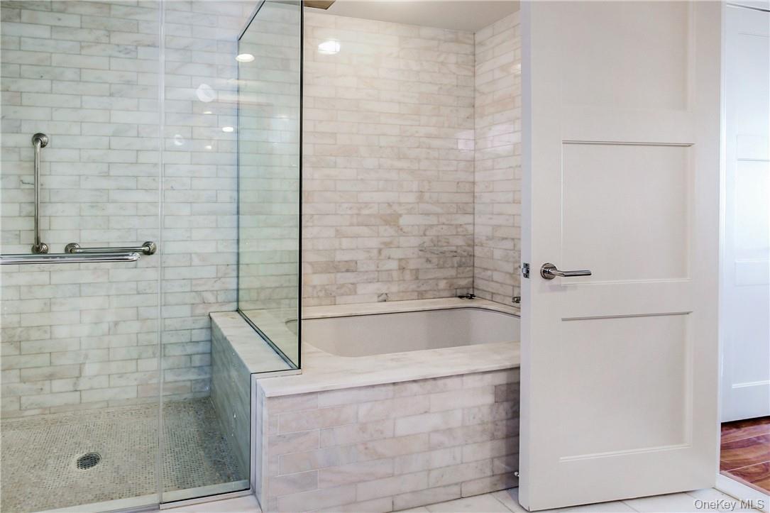1 Renaissance Square, Unit 11G White Plains, NY 10601 - Photo 10 of 23 a bathroom with a bathtub and a shower