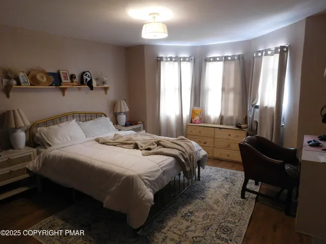 a bedroom with a bed and a window