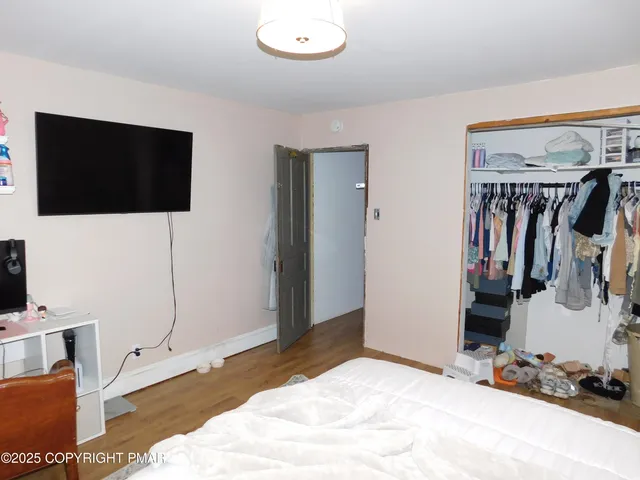a bedroom with a bed and a flat screen tv