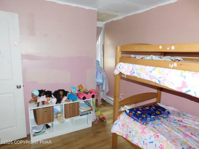 a bed room with wooden floor and furniture