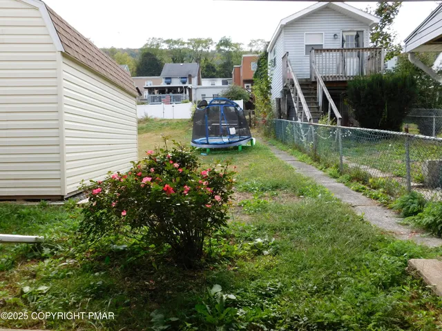 a view of a house with a yard from a balcony