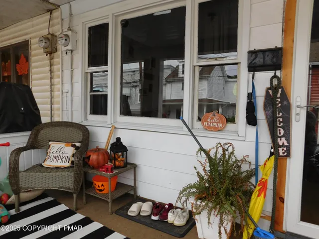 a vase of flowers sitting on a table in front of a window