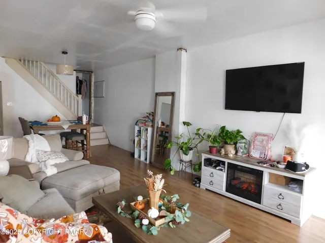 a living room with furniture and a flat screen tv