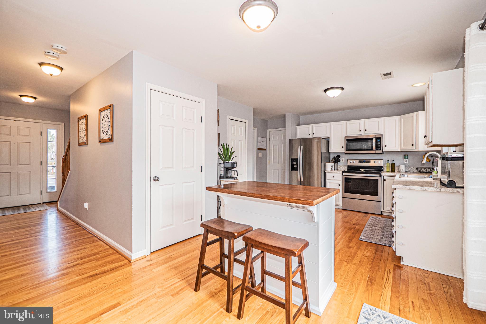 405 McClellan Drive Frederick, MD 21702 - Photo 12 of 39 a kitchen with stainless steel appliances granite countertop a refrigerator and a stove top oven