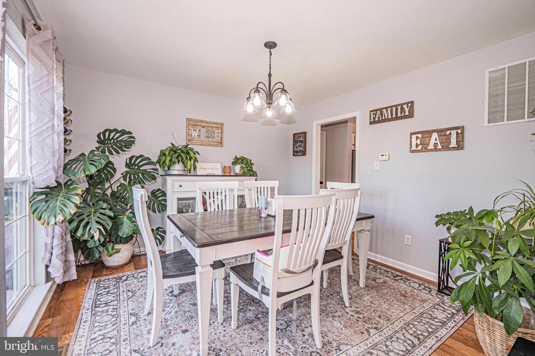 405 McClellan Drive Frederick, MD 21702 - Photo 19 of 39 a dining room with furniture potted plants and wooden floor