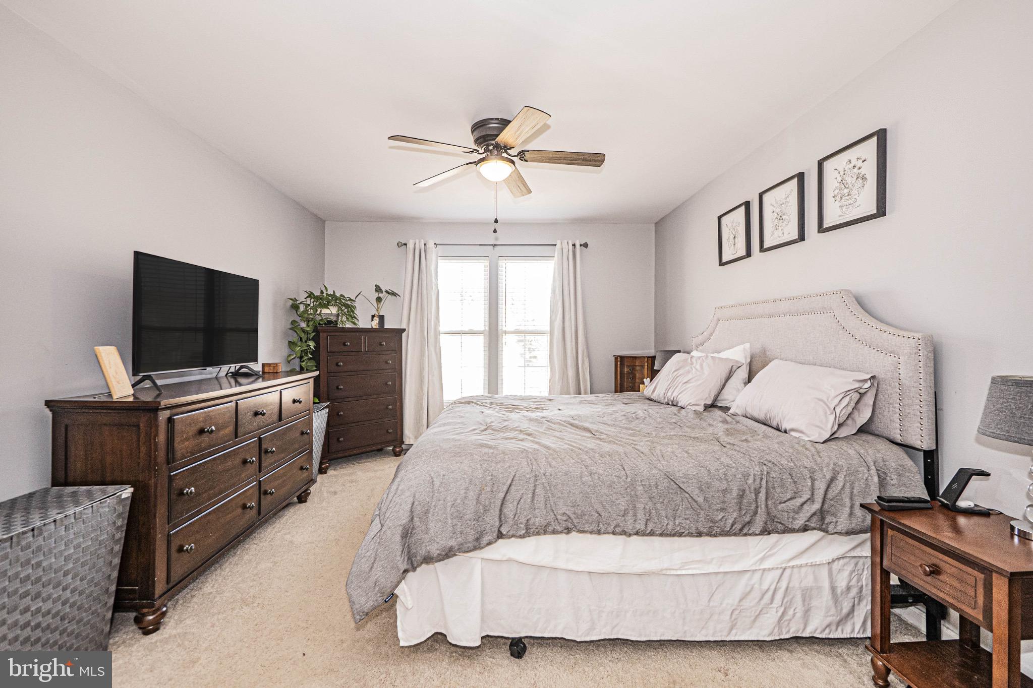 405 McClellan Drive Frederick, MD 21702 - Photo 24 of 39 a bedroom with a bed and a flat screen tv