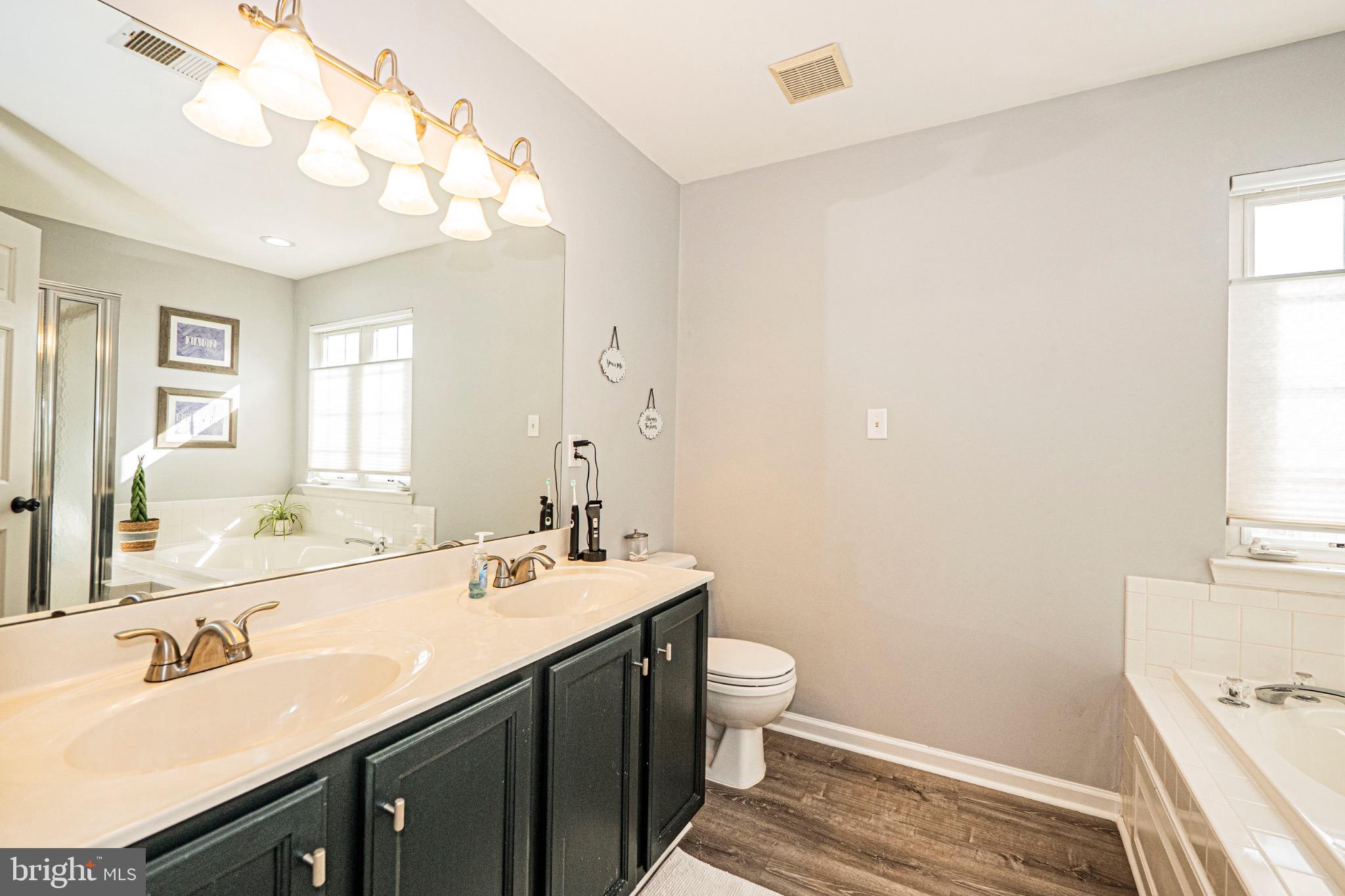 405 McClellan Drive Frederick, MD 21702 - Photo 26 of 39 a bathroom with a double vanity sink mirror and toilet