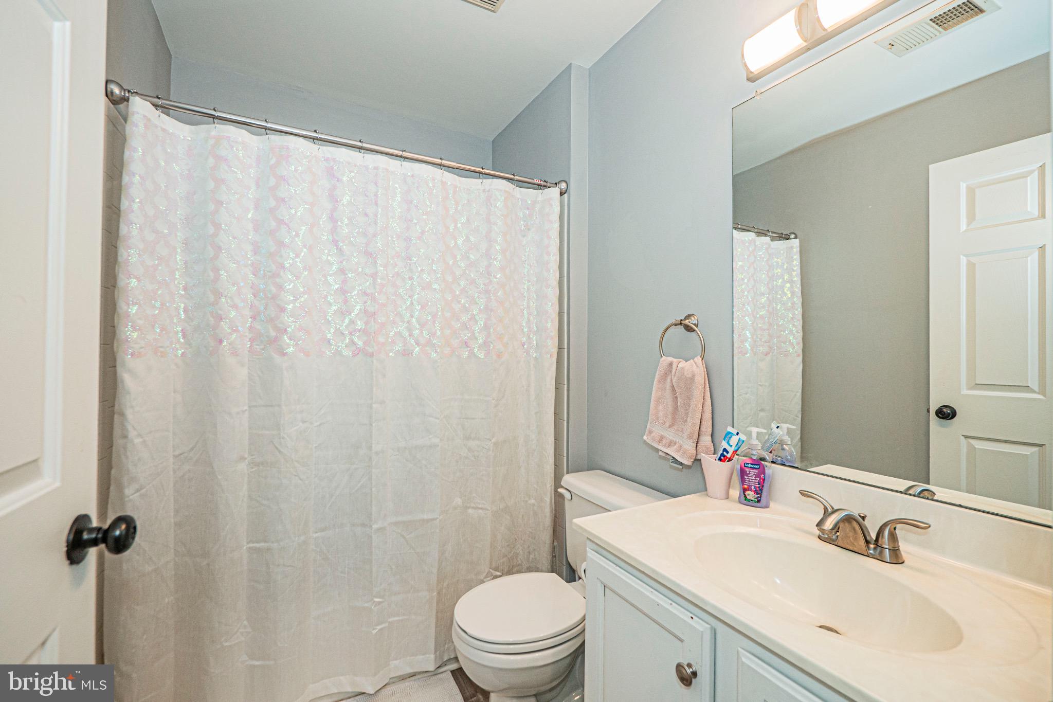 405 McClellan Drive Frederick, MD 21702 - Photo 28 of 39 a bathroom with a sink a toilet and a mirror