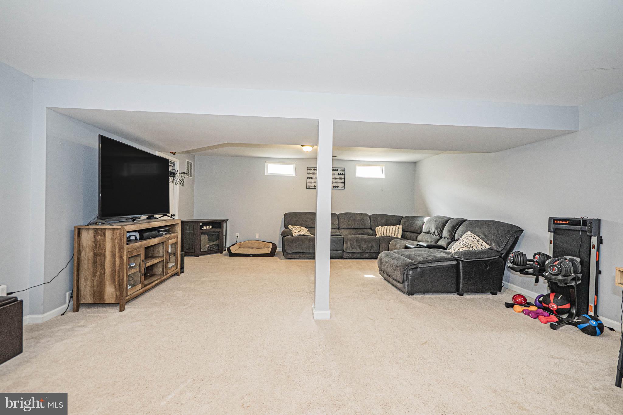 405 McClellan Drive Frederick, MD 21702 - Photo 32 of 39 a living room with furniture and a flat screen tv