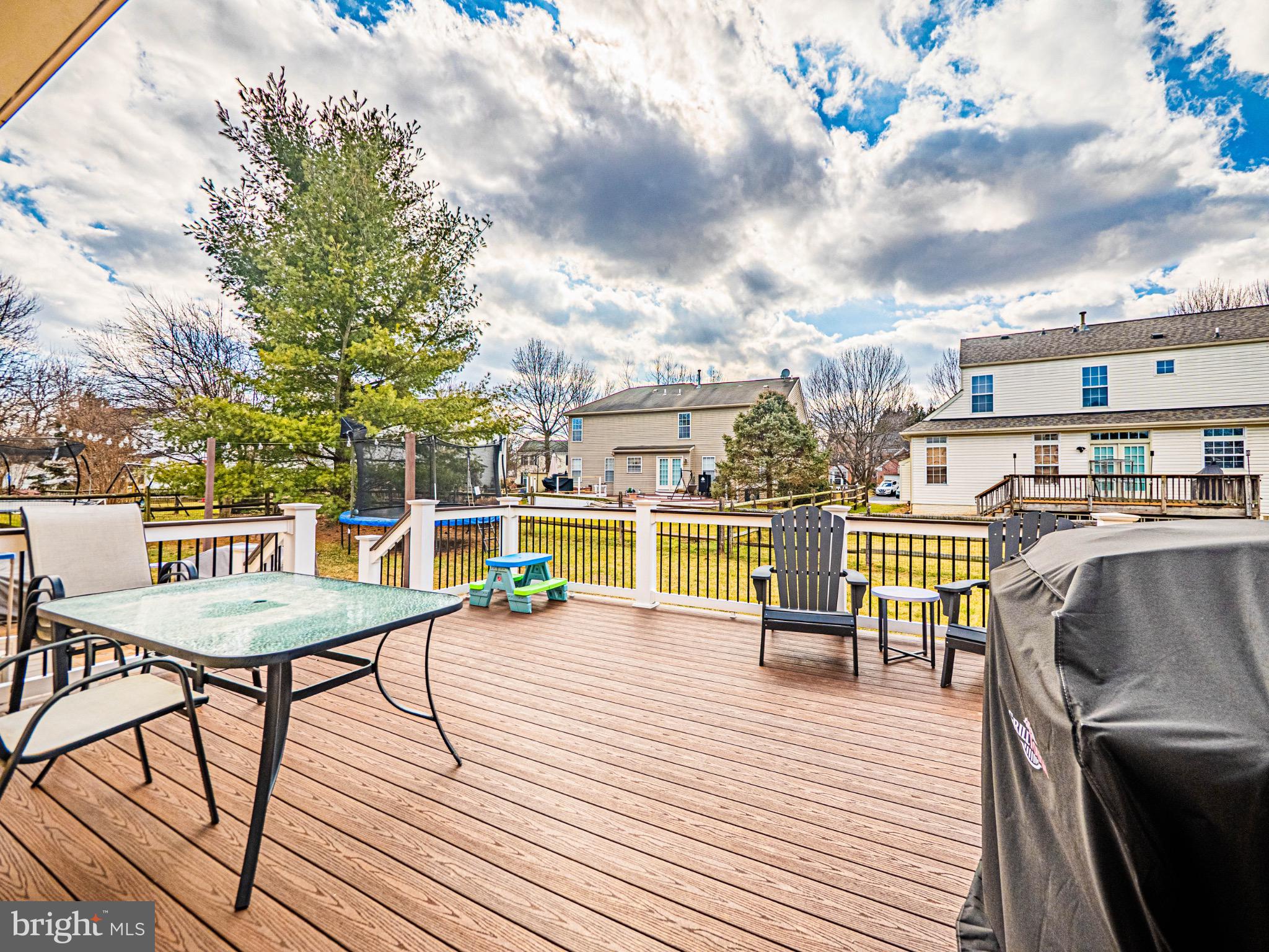 405 McClellan Drive Frederick, MD 21702 - Photo 38 of 39 a view of a rooftop deck with dining table and chairs with wooden floor