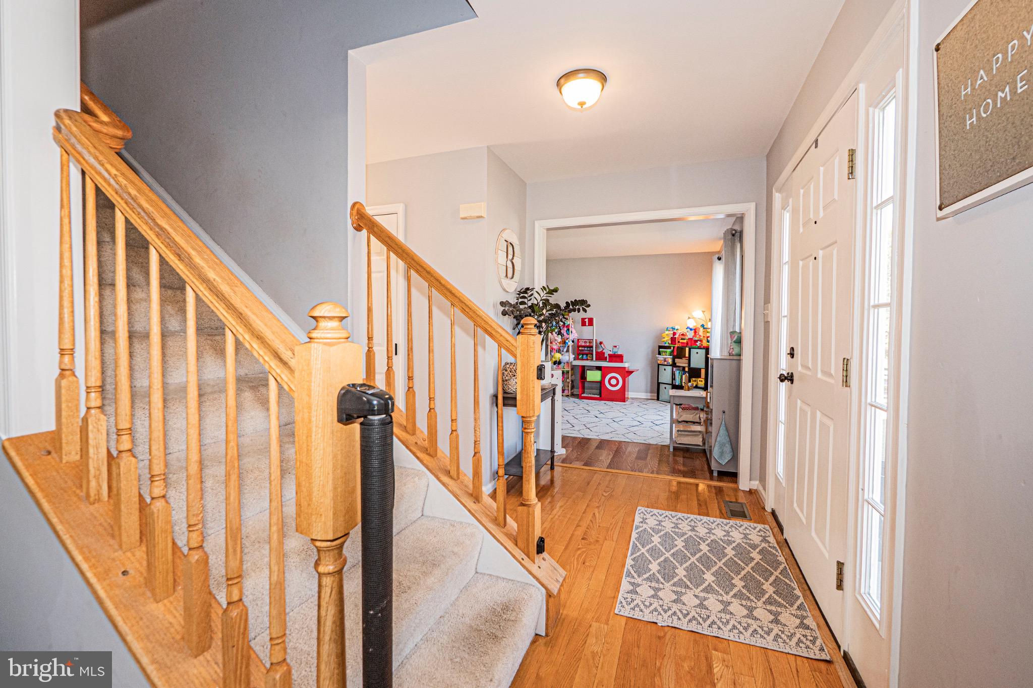 405 McClellan Drive Frederick, MD 21702 - Photo 5 of 39 a view of a hallway with wooden floor and stairs