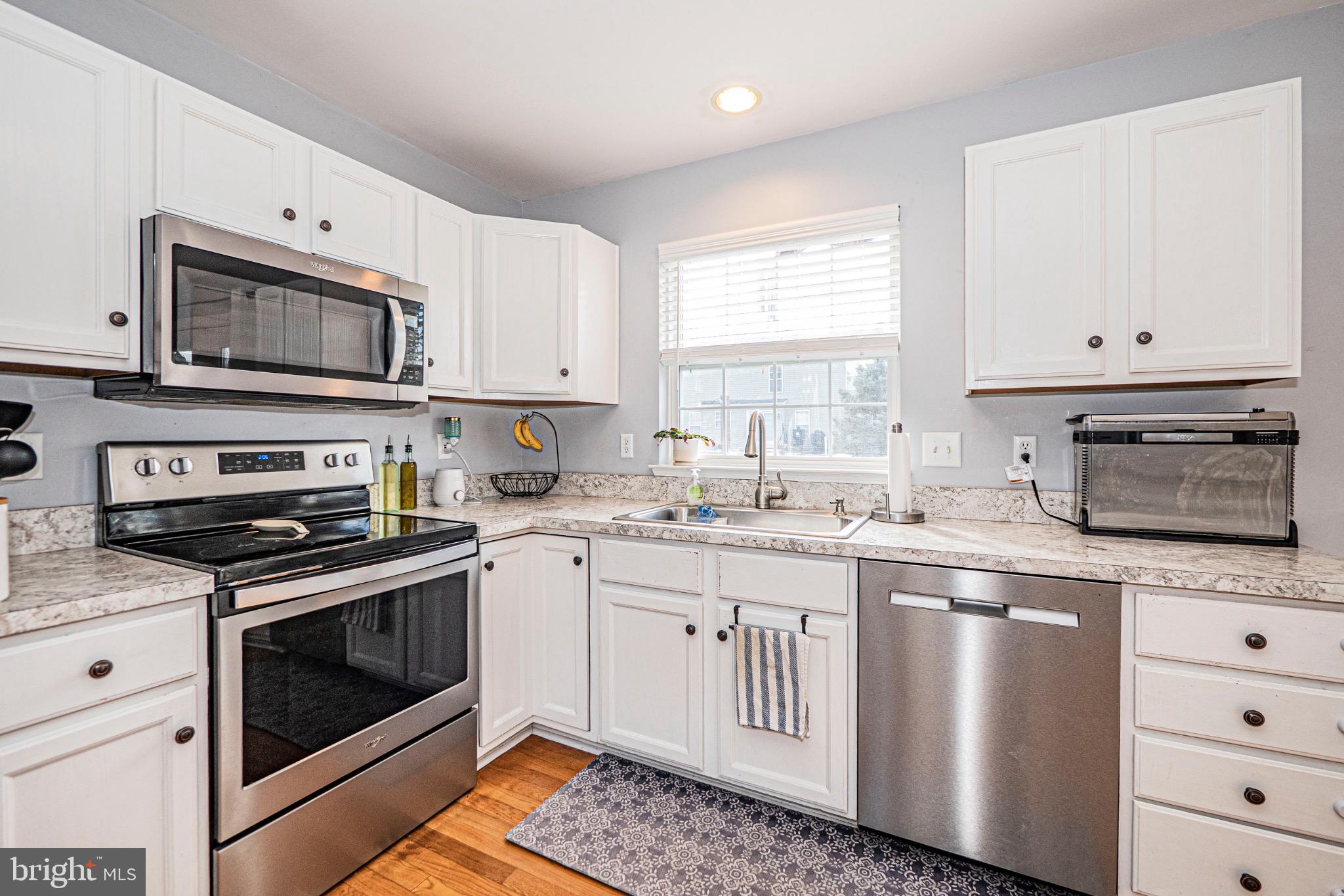 405 McClellan Drive Frederick, MD 21702 - Photo 9 of 39 a kitchen with stainless steel appliances granite countertop a stove a sink and a microwave