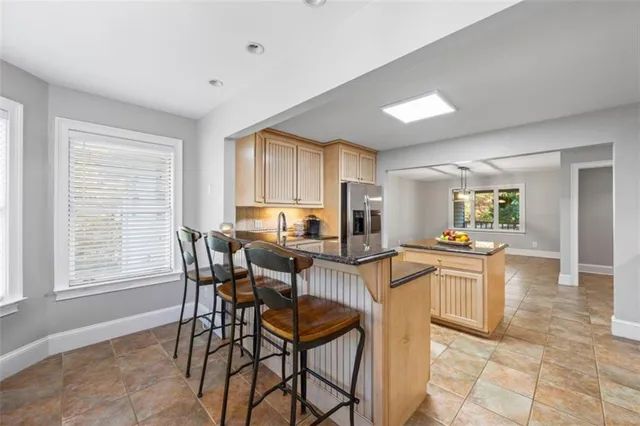 a view of a hallway with wooden floor and windows