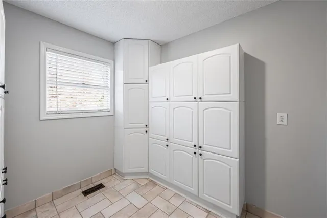 a view of an empty room and wooden floor