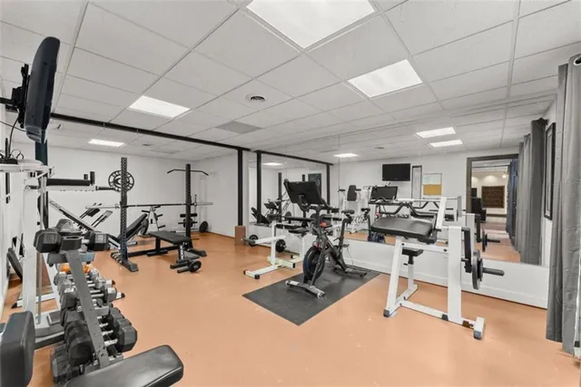 a view of empty room with wooden floor and ceiling fan