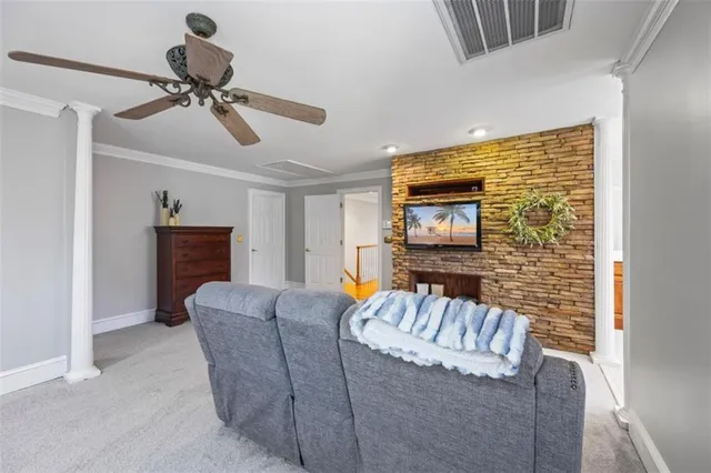 a living room with furniture gym equipment and a large window