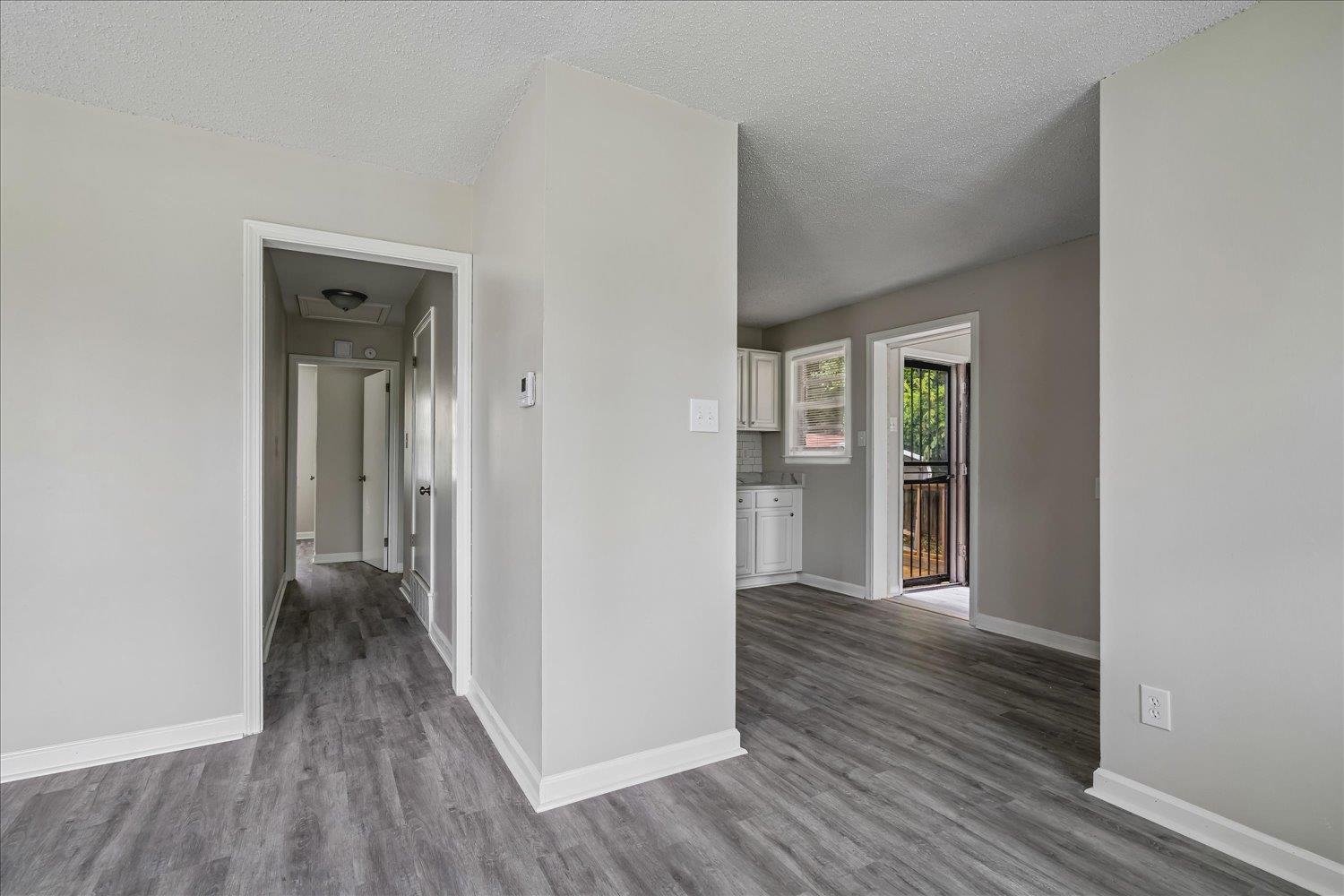 2518 Manchester Road Memphis, TN 38114 - Photo 13 of 23 Entryway featuring wood-finish flooring, light gray walls, white trim, and a flush mount ceiling light