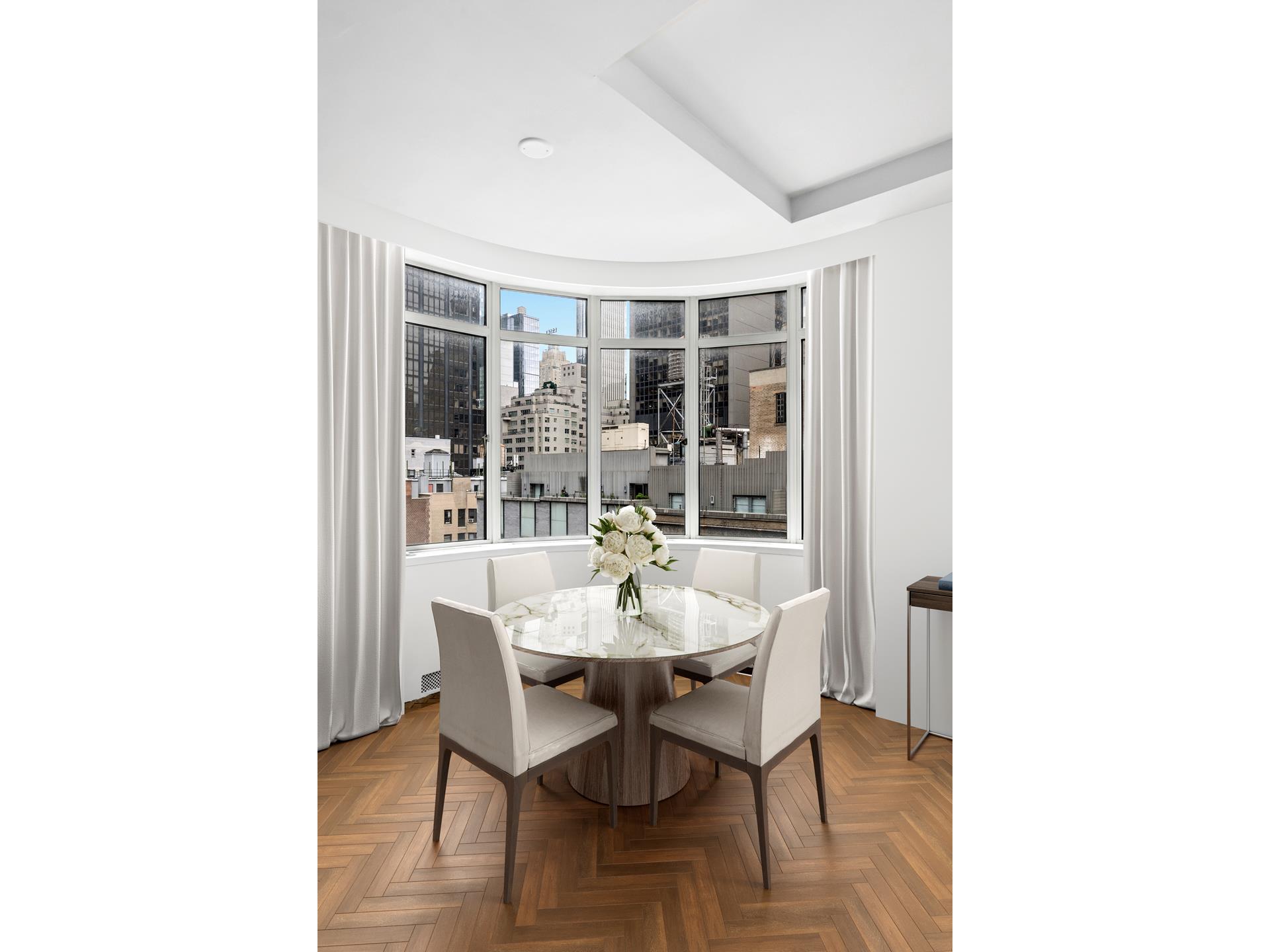 24 West 55th Street, Unit 11D Manhattan, NY 10019 - Photo 3 of 18 a dining room with furniture and window
