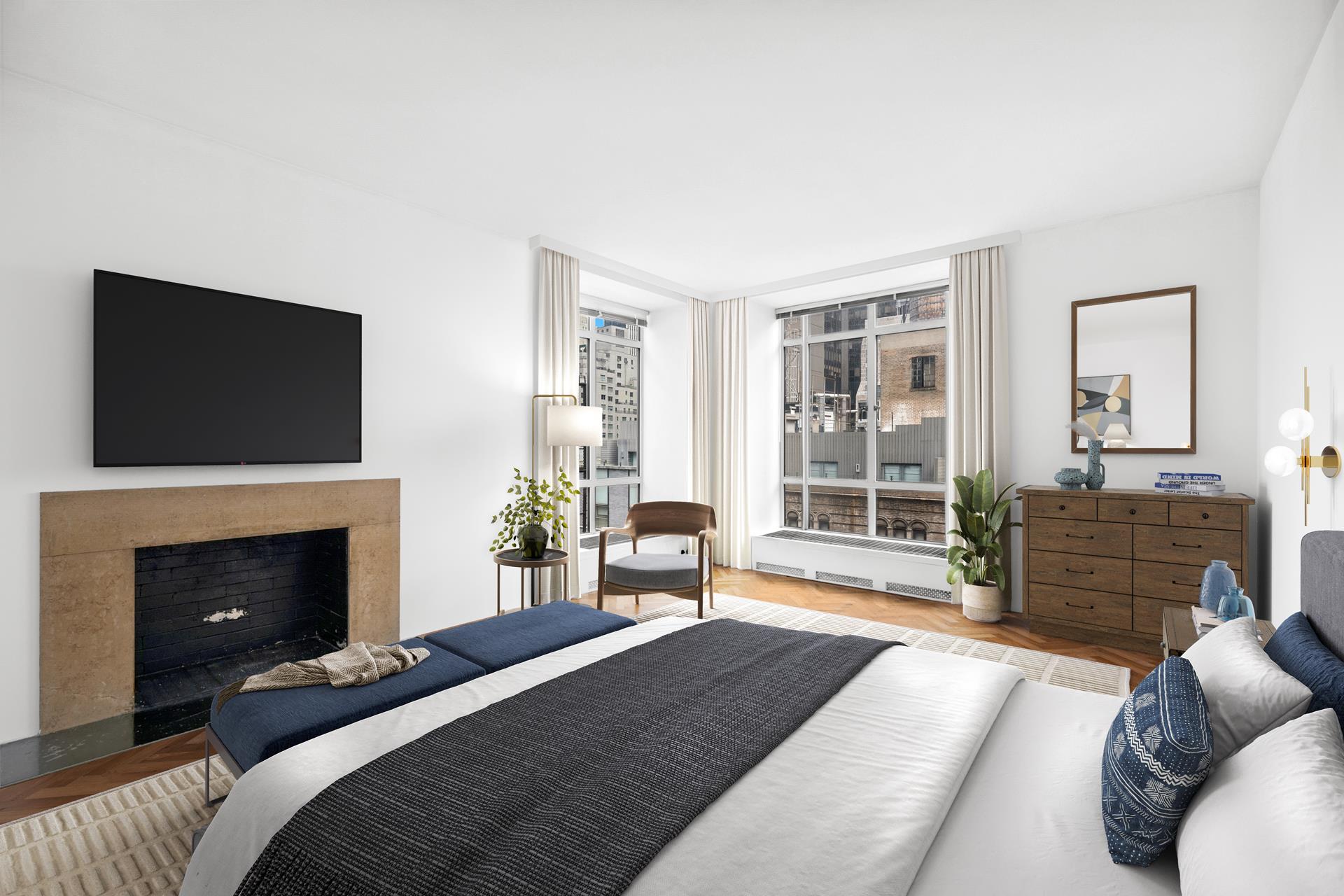 24 West 55th Street, Unit 11D Manhattan, NY 10019 - Photo 8 of 18 a bedroom with a bed and a fireplace